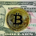 a bitcoin and 50 dollars note