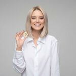 a woman holding a bitcoin
